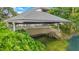 A covered boat house on a waterway with stair access to the water at 2504 Gatlin Ave, Orlando, FL 32806