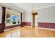Charming dining room with decorative wallpaper and a chandelier at 2504 Gatlin Ave, Orlando, FL 32806