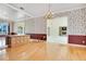Formal dining room featuring a large mirror and hardwood flooring at 2504 Gatlin Ave, Orlando, FL 32806