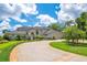 Stately two-story home featuring a circular driveway and lush, manicured landscaping at 2504 Gatlin Ave, Orlando, FL 32806