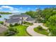 Stately two-story home featuring a circular driveway and lush, manicured landscaping and lake view at 2504 Gatlin Ave, Orlando, FL 32806