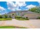 A classic two-story home featuring a three car garage, well-manicured lawn and a circular driveway at 2504 Gatlin Ave, Orlando, FL 32806