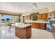 Spacious kitchen boasts a breakfast nook with lake view, an island, and wood cabinets at 2504 Gatlin Ave, Orlando, FL 32806