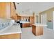 Spacious kitchen featuring tile flooring, wood cabinetry, and a large island at 2504 Gatlin Ave, Orlando, FL 32806