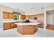 Traditional kitchen features wood cabinets, white countertops, tile flooring, and a center island at 2504 Gatlin Ave, Orlando, FL 32806