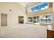 Expansive living room with high ceilings, large windows offering waterfront views and neutral carpeting at 2504 Gatlin Ave, Orlando, FL 32806