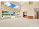 Bright living room with neutral carpet, large windows, and views of the lake and swimming pool at 2504 Gatlin Ave, Orlando, FL 32806