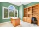 Bright office featuring green walls, a large window, and a built-in bookcase and desk at 2504 Gatlin Ave, Orlando, FL 32806