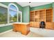 Bright office featuring green walls, a large window, and a built-in bookcase and desk at 2504 Gatlin Ave, Orlando, FL 32806