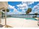 Inviting backyard pool and patio with a beautiful view of the lake and landscaping at 2504 Gatlin Ave, Orlando, FL 32806