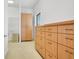 Bright storage room with built-in wooden cabinets and shelving offers ample organizational space at 2504 Gatlin Ave, Orlando, FL 32806