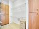Storage area with wooden cabinets, metal shelving, and a small filing cabinet at 2504 Gatlin Ave, Orlando, FL 32806