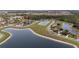 Aerial view of neighborhood with serene lake views and well-maintained landscaping at 2831 Orange Haven Way, Kissimmee, FL 34746