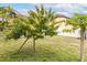 Well-maintained backyard features vibrant trees and lush green grass at 2831 Orange Haven Way, Kissimmee, FL 34746