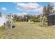 Expansive backyard featuring lush greenery, pergola, basketball court, and ample space at 2831 Orange Haven Way, Kissimmee, FL 34746
