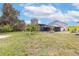 Spacious backyard featuring green grass, a private pool and a screened lanai at 2831 Orange Haven Way, Kissimmee, FL 34746