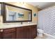 Well-lit bathroom featuring granite countertops, and a large mirror at 2831 Orange Haven Way, Kissimmee, FL 34746