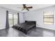 Contemporary bedroom with vinyl plank floors, ceiling fan, and a large window at 2831 Orange Haven Way, Kissimmee, FL 34746