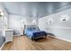Comfortable bedroom with a plush bed, ambient lighting, and light hardwood floors at 2831 Orange Haven Way, Kissimmee, FL 34746