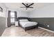 Comfortable bedroom with hardwood floors, neutral gray walls, a ceiling fan, and a window at 2831 Orange Haven Way, Kissimmee, FL 34746
