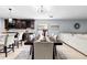 Open dining room with a dark wood table, seating for eight, and modern light fixture at 2831 Orange Haven Way, Kissimmee, FL 34746