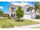 Charming two-story home featuring a well-manicured lawn and mature trees at 2831 Orange Haven Way, Kissimmee, FL 34746
