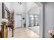 Bright foyer featuring tile flooring, an elegant mirror, and an arched doorway at 2831 Orange Haven Way, Kissimmee, FL 34746