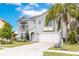 Beautiful two-story home features a manicured lawn, and a two-car garage at 2831 Orange Haven Way, Kissimmee, FL 34746