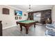 Entertainment room with a pool table, accent wall, and rustic decor at 2831 Orange Haven Way, Kissimmee, FL 34746