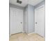 Hallway featuring fresh paint, tile floors, and multiple doors at 2831 Orange Haven Way, Kissimmee, FL 34746