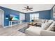 Bright living room features a ceiling fan, large sectional sofa, and a mounted television, perfect for relaxing and entertaining at 2831 Orange Haven Way, Kissimmee, FL 34746