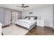 Main bedroom features wood floors, neutral gray walls, a ceiling fan, and a sliding glass door at 2831 Orange Haven Way, Kissimmee, FL 34746