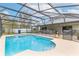 Inviting screened-in pool area perfect for relaxing and entertaining in a private backyard oasis at 2831 Orange Haven Way, Kissimmee, FL 34746