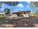 An exterior view shows the home with a large backyard and screened in porch on a sunny day at 2833 Ne 18Th Ct, Ocala, FL 34470