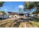 Home's backyard features mature trees, offering privacy and shade, with the house and screened-in porch visible at 2833 Ne 18Th Ct, Ocala, FL 34470