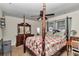 Bright bedroom with a four poster bed, ceiling fan and dresser at 2833 Ne 18Th Ct, Ocala, FL 34470