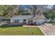 Charming single-story home with a well-manicured lawn, brick accents, and an attached one car garage at 2833 Ne 18Th Ct, Ocala, FL 34470