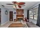 Inviting living room with a wood burning fireplace, a window with curtains, and tile flooring at 2833 Ne 18Th Ct, Ocala, FL 34470
