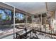 Screened-in lanai offers a view of the spacious backyard with mature trees, providing an ideal space for outdoor relaxation at 2833 Ne 18Th Ct, Ocala, FL 34470