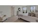 Well-lit bedroom featuring a cozy chair, dresser, and a doorway leading to the bathroom at 2972 Moulin Rd, Davenport, FL 33837