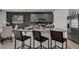 Modern kitchen features a granite island, stainless steel appliances, and stylish barstool seating at 2972 Moulin Rd, Davenport, FL 33837