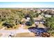 An aerial view of a home with a pool, shed, and lush greenery showcases the property's appeal at 32804 Blossom Ln, Leesburg, FL 34788