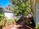 Backyard landscaping with a walkway, offering a tranquil path through the greenery, enhanced by a decorative birdhouse at 32804 Blossom Ln, Leesburg, FL 34788