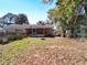 View of a sprawling backyard, featuring a screened porch and plenty of space for outdoor activities and enjoyment at 32804 Blossom Ln, Leesburg, FL 34788
