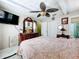 Cozy bedroom with a comfortable bed, a ceiling fan, and an elegant wooden dresser at 32804 Blossom Ln, Leesburg, FL 34788