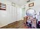 Bedroom featuring wood-look flooring, vanity area, and closet doors at 32804 Blossom Ln, Leesburg, FL 34788