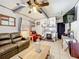 Cozy living room with exposed beams, stone fireplace, and comfortable leather seating at 32804 Blossom Ln, Leesburg, FL 34788
