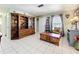 Well-lit living room with an elegant built-in bookcase, neutral walls, and a cozy reading nook at 32804 Blossom Ln, Leesburg, FL 34788