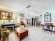 Open-concept living room featuring arched doorways, decorative fireplace, and tiled floors at 32804 Blossom Ln, Leesburg, FL 34788