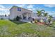 Beautiful backyard with a patio, lush green lawn, palm trees, and well-manicured landscaping for outdoor enjoyment at 365 Quarry Rock Cir, Kissimmee, FL 34758